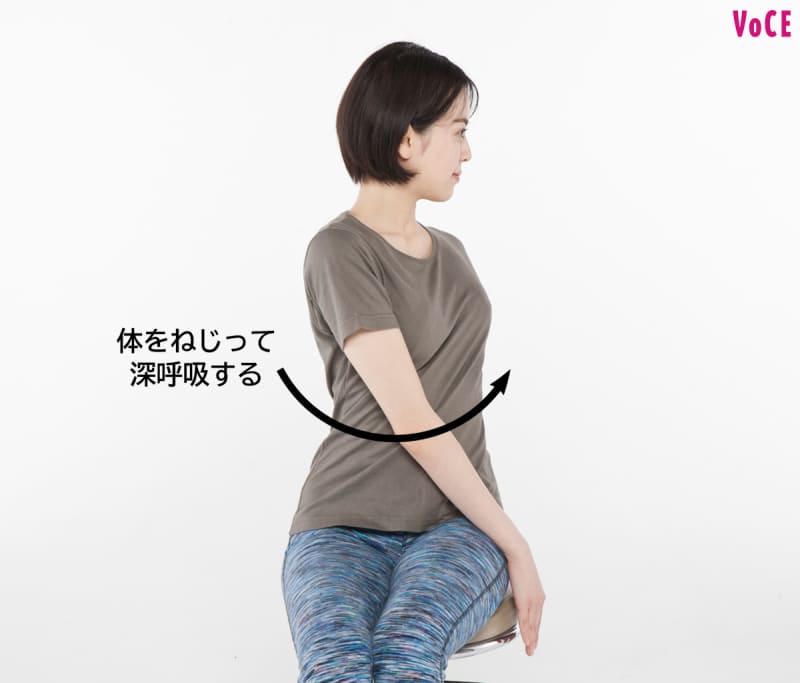体をねじって深呼吸する