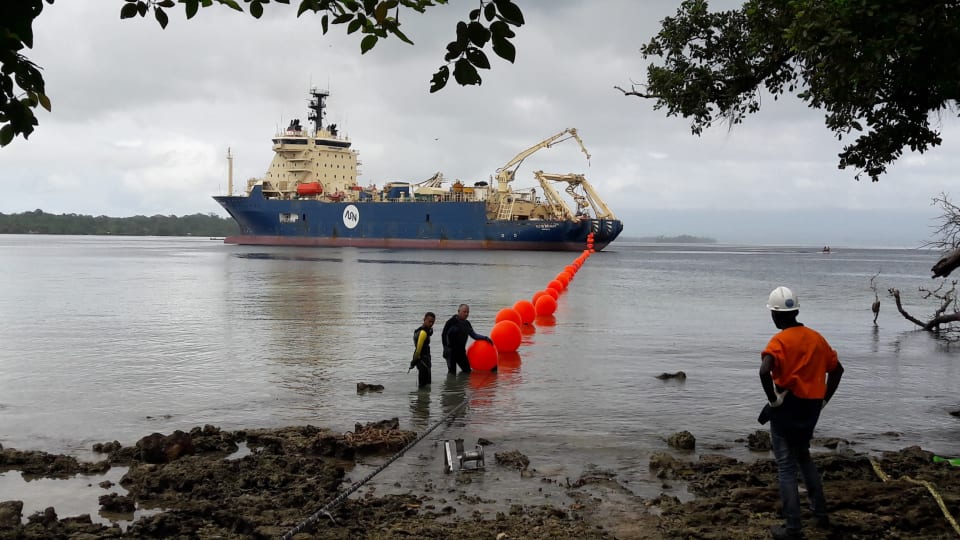 The Solomon Islands Domestic Network cable is floated ashore at Noro from the specialist cable-laying vessel the Ile de Brehat. The cable can be seen in the foreground (Credit: Simon Cluer, ASN)