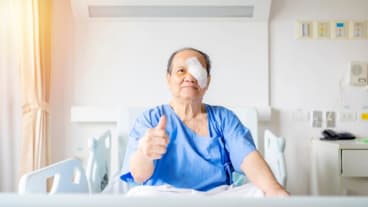 Cataract surgery for international patients : a patient expresses satisfaction while seated on his bed.