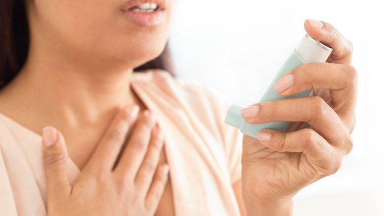 Illustration d'une femme tenant à la main son inhalateur en pleine crise 