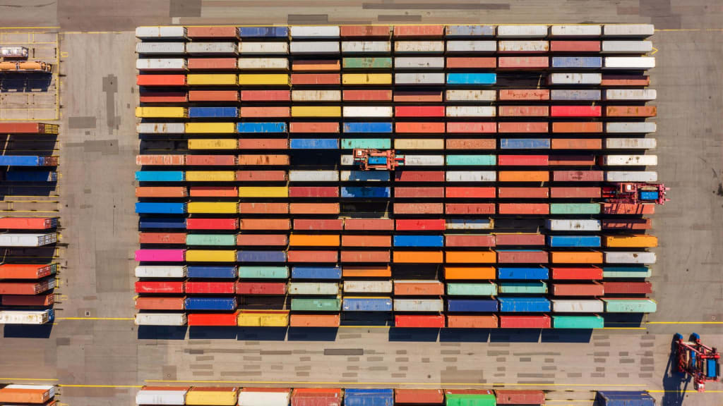 A picture of shipping containers in a port