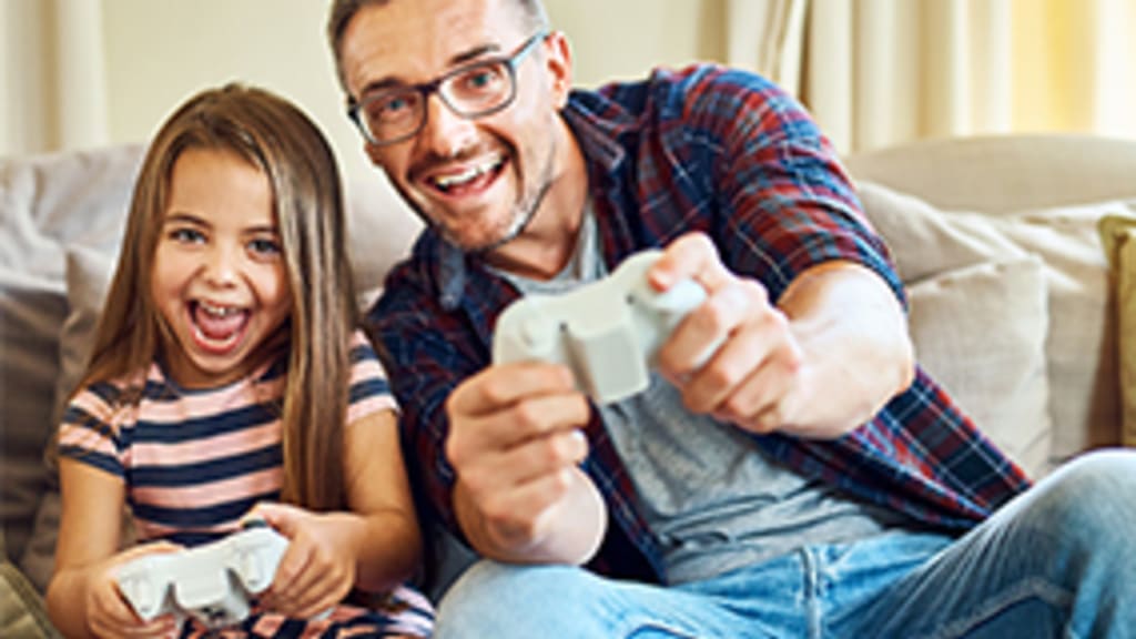 Vater und Tochter beim Videospiel Symbolbild