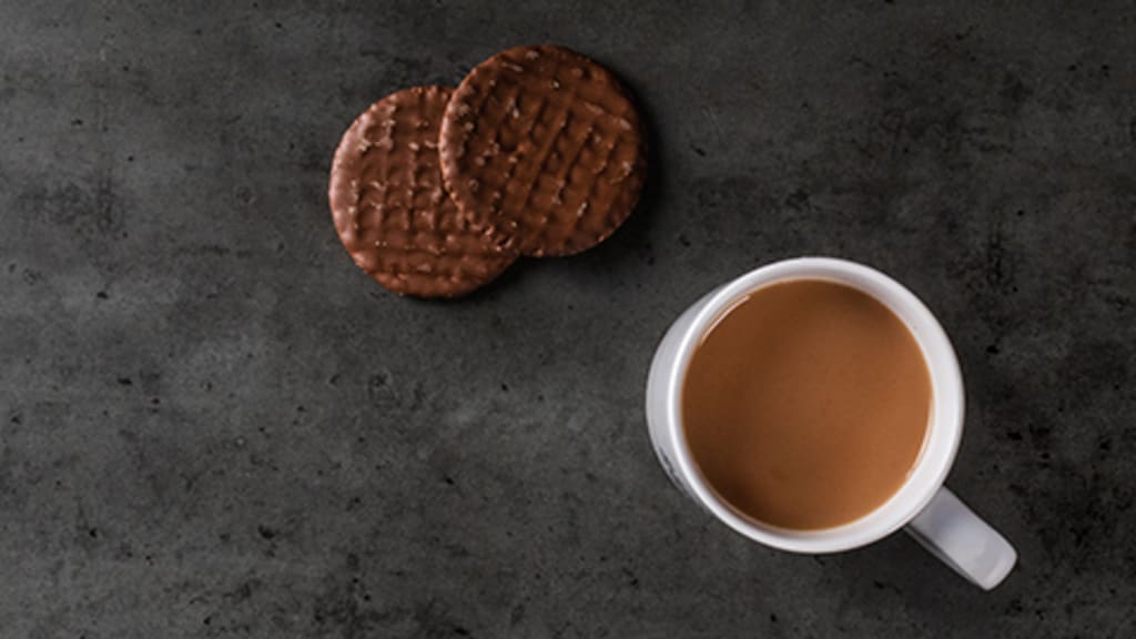 A coffee mug with cookies Header 