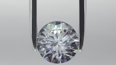 Ein silbrigen Diamant im Fokus und eine Pinzette