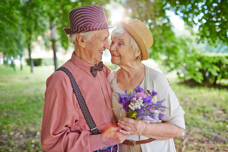 Old couple in fruit orchard