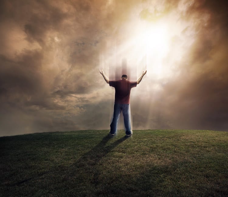 Man lifting up his soul and arms on grassy field