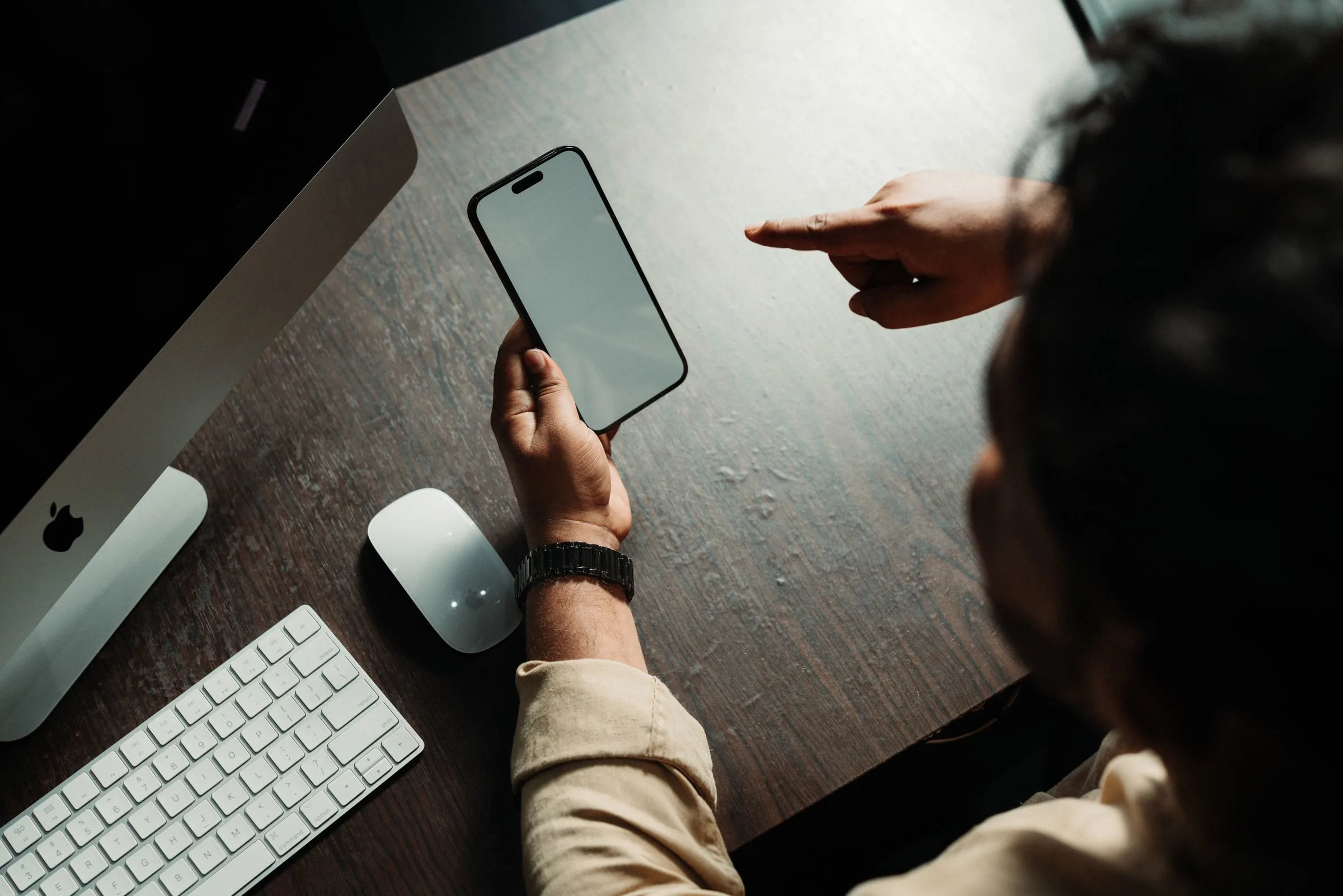 A smartphone and desktop computer on a desk