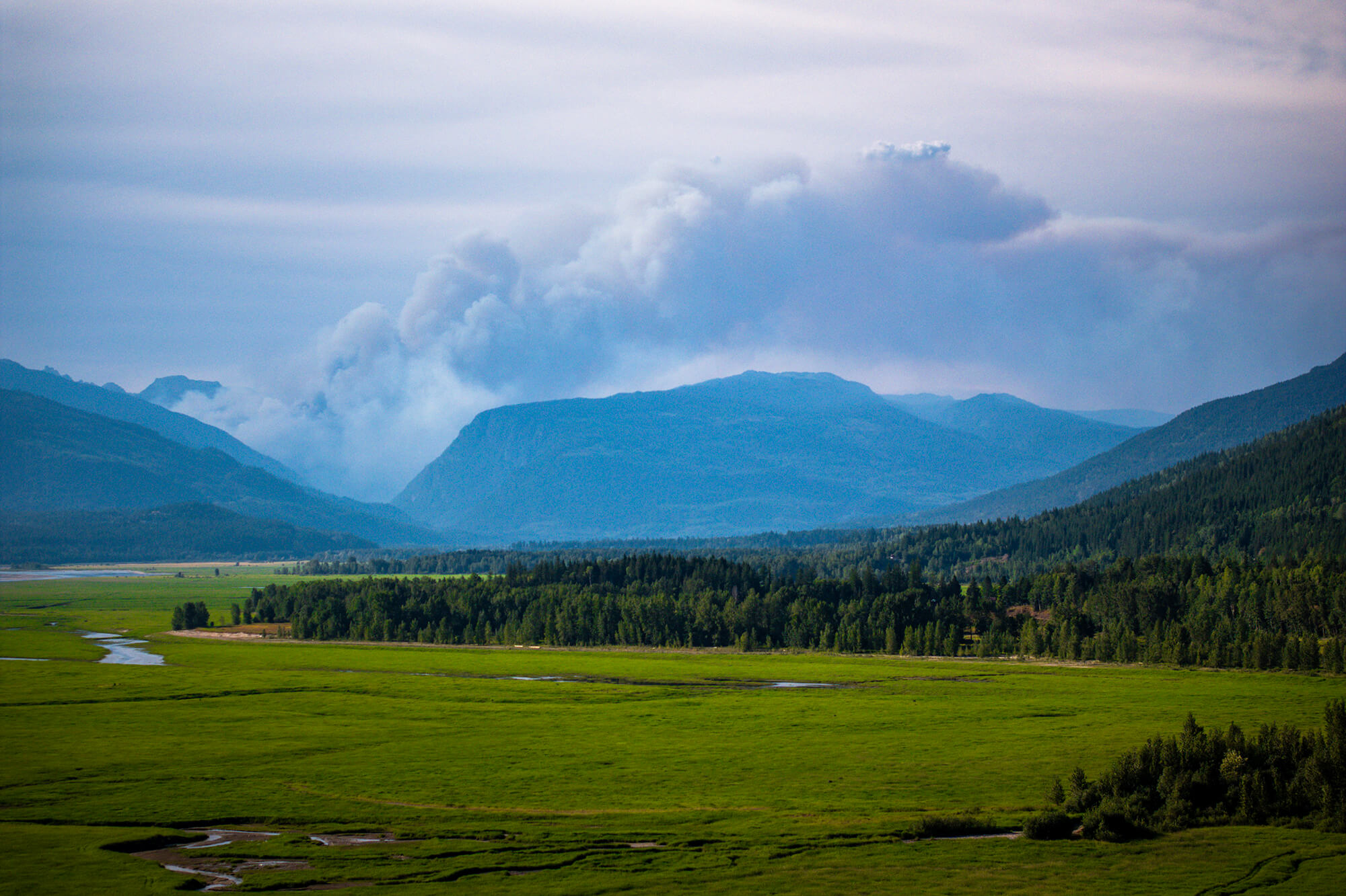 Wildfire raging behind a bridge in Revelstoke BC