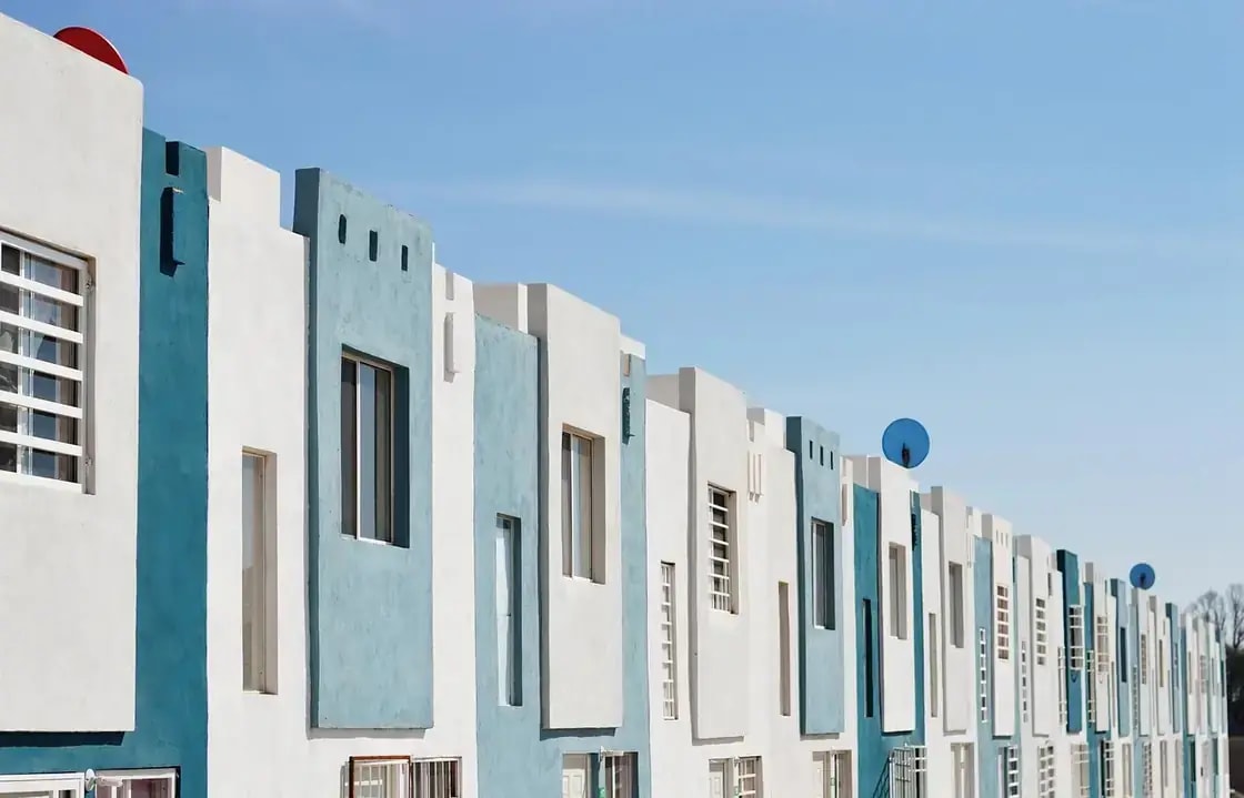 A row of modern townhouses under a clear sky