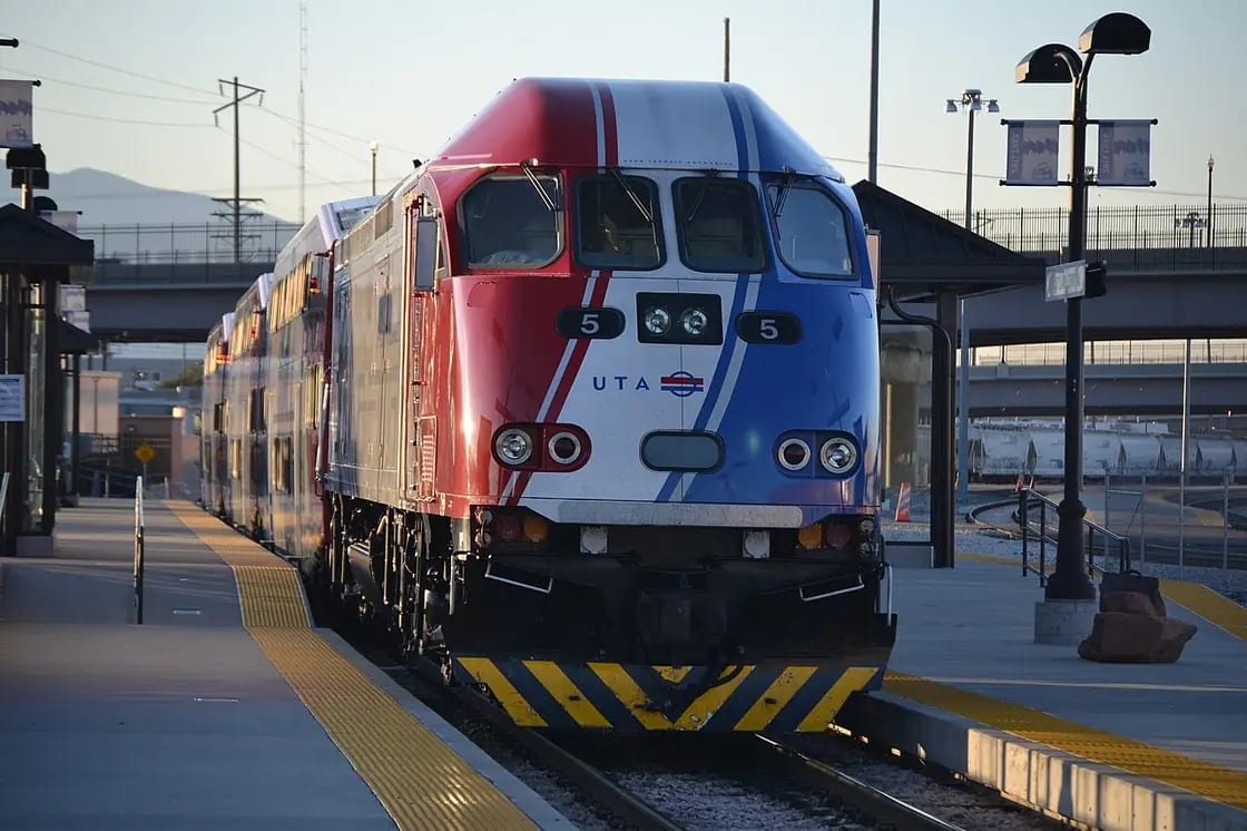 A FrontRunner commuter train waiting at a station platform on the Utah Transit Authority line