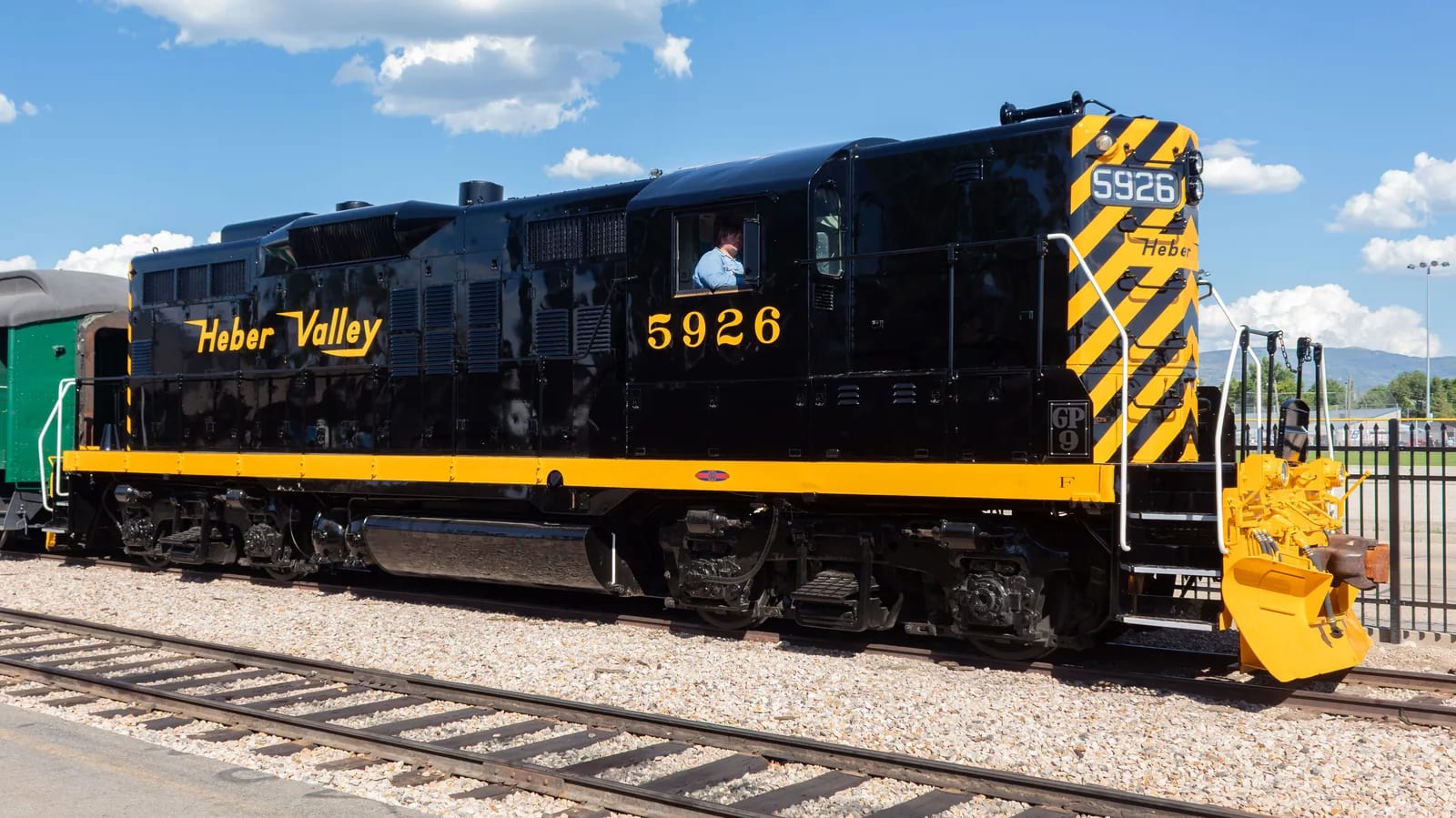A black and yellow diesel locomotive lettered Heber Valley and numbered 5926, standing on track at a depot