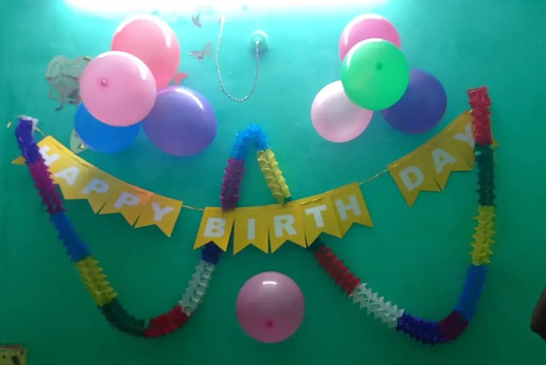 Kids celebrating a birthday party with balloons and cake in the Provo, Utah area