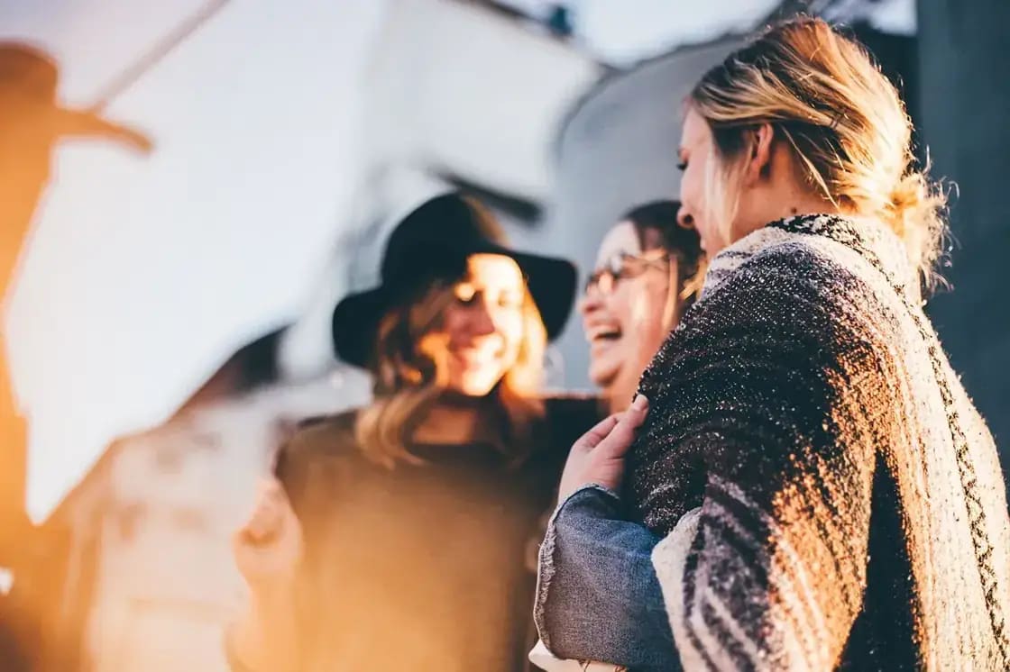 A group of friends laughing together outdoors