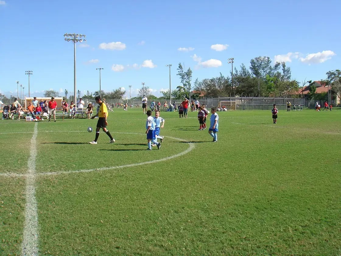 Youth soccer players competing on a grass field