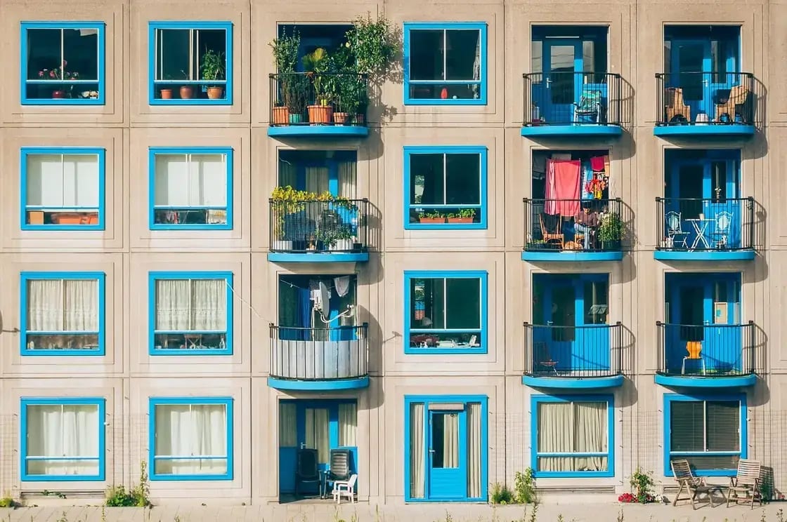 Balconies and blue-framed windows on an apartment building facade