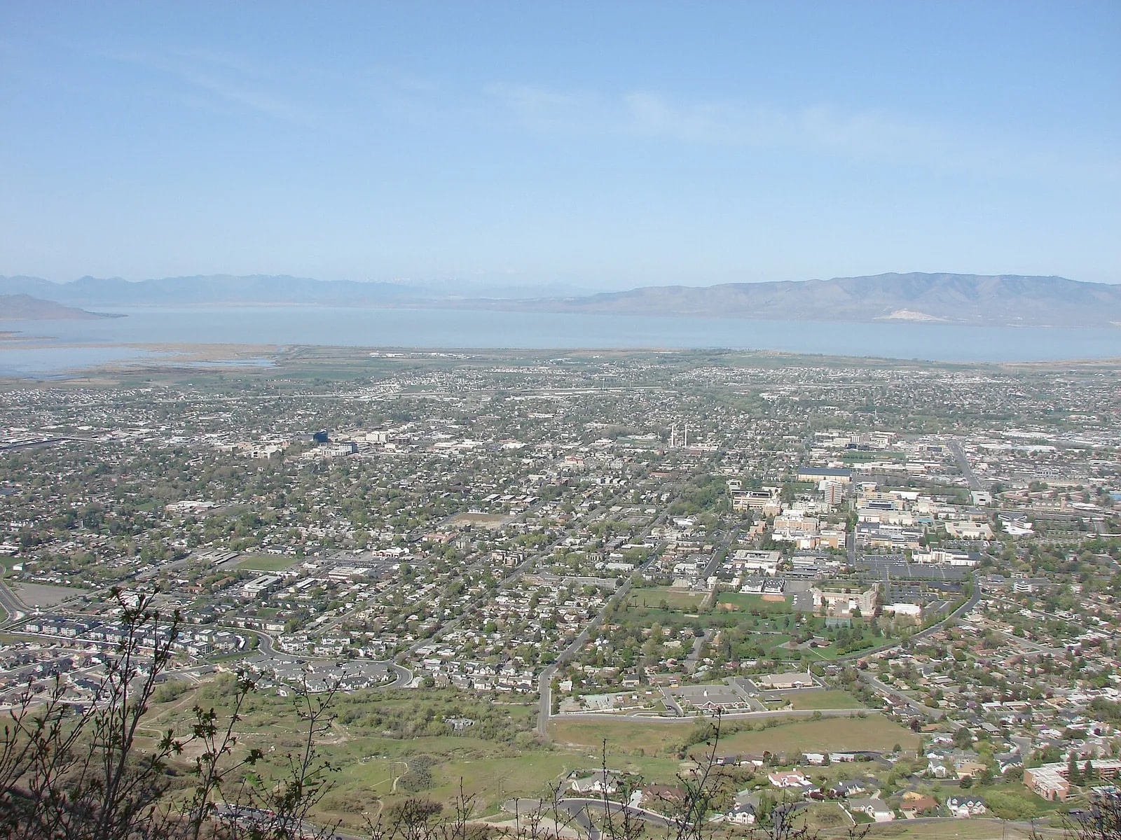 North Provo spread across the valley floor seen from high on Y Mountain, with Utah Lake and the mountains beyond its far shore