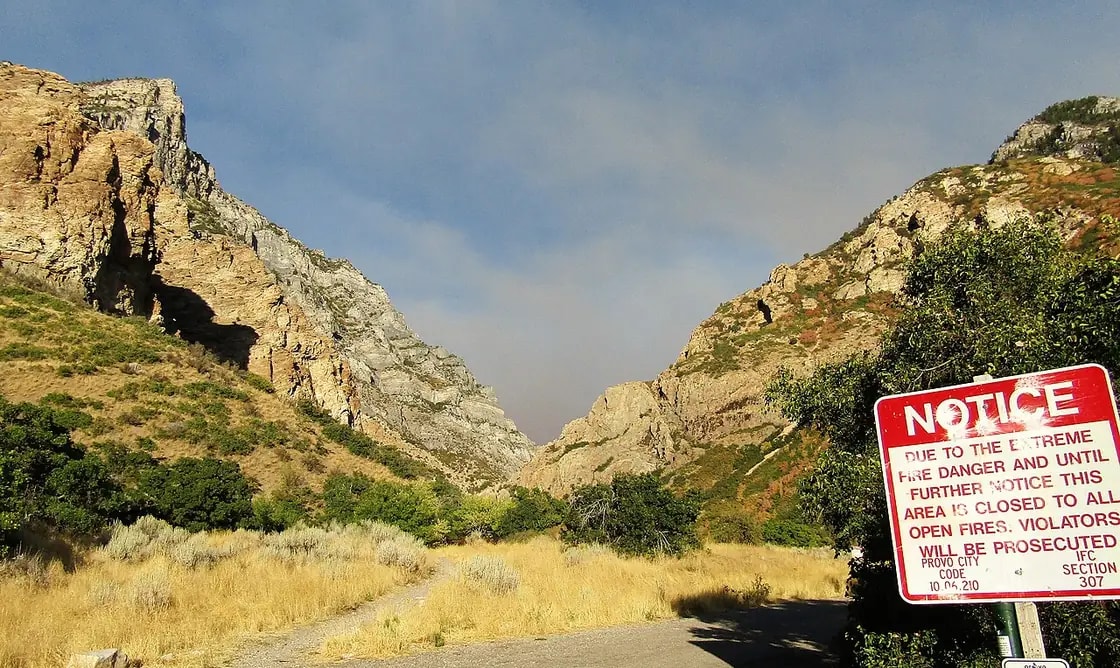 The mouth of Rock Canyon east of Provo, with the trail running in between limestone cliffs past a Provo City fire-restriction notice