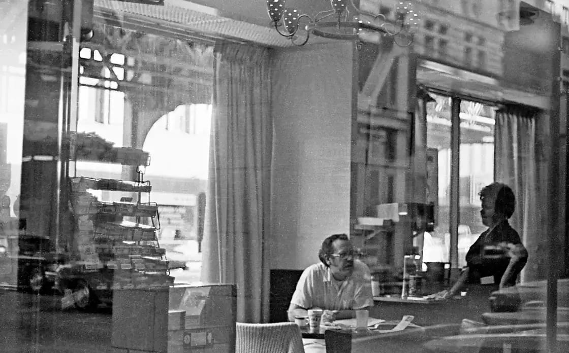 A worker behind the counter at a coffee shop
