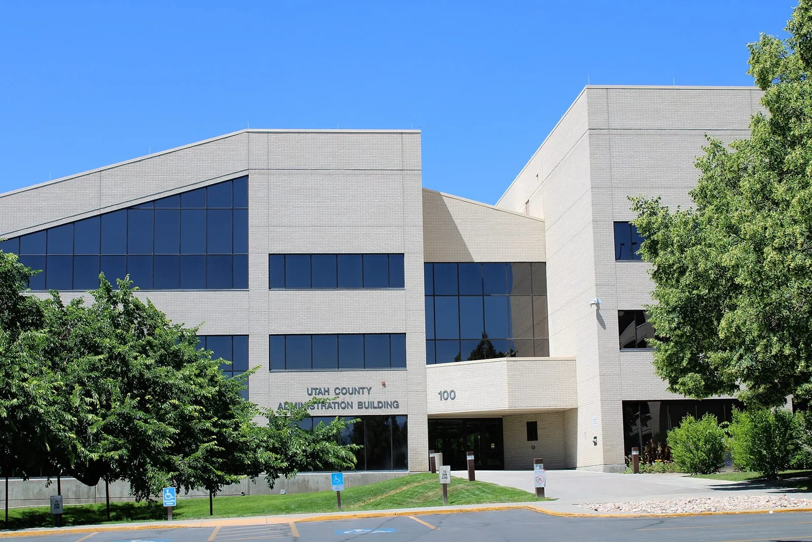 The Utah County Administration Building in Provo, its name and street number on the entrance sign