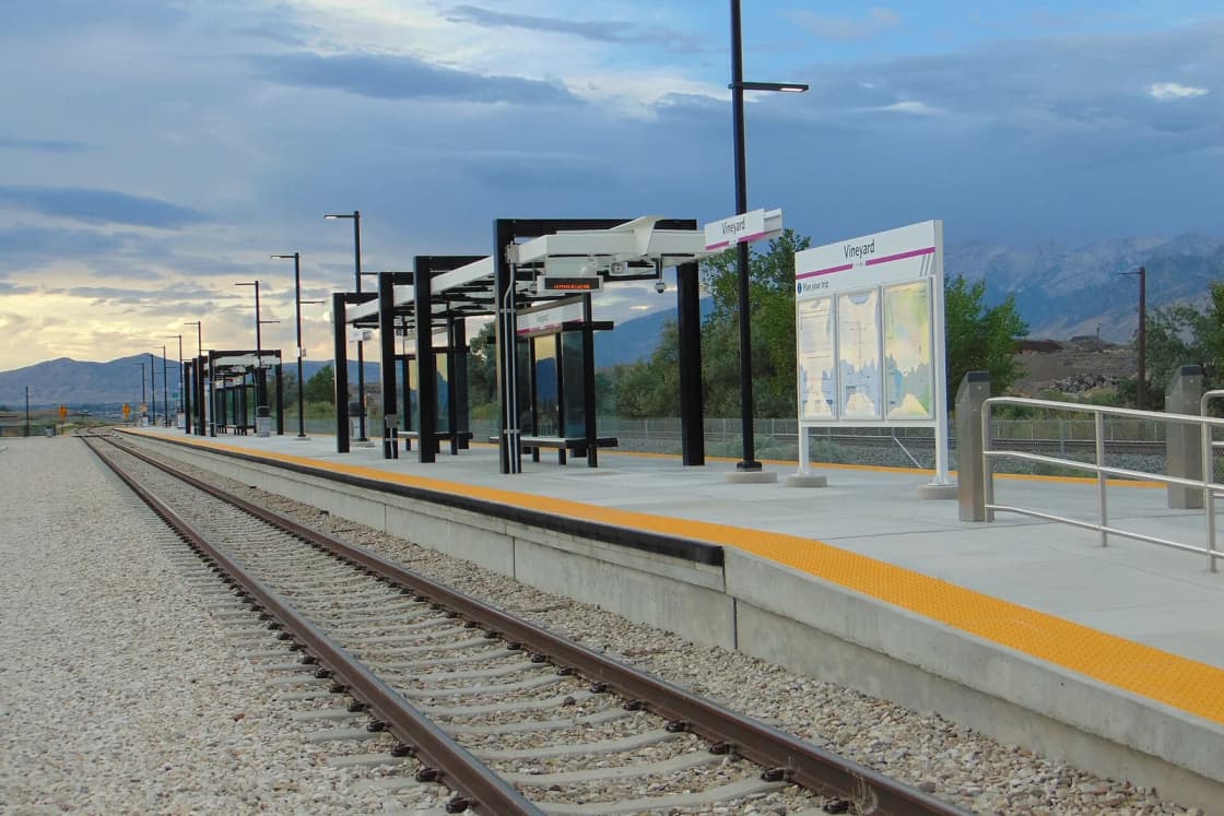 The FrontRunner platform at Vineyard station in Vineyard, Utah, with mountains under an evening sky.