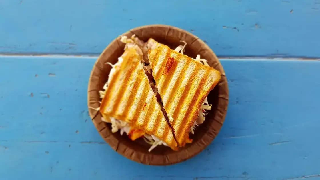 A pressed grilled sandwich cut in half and served in a basket
