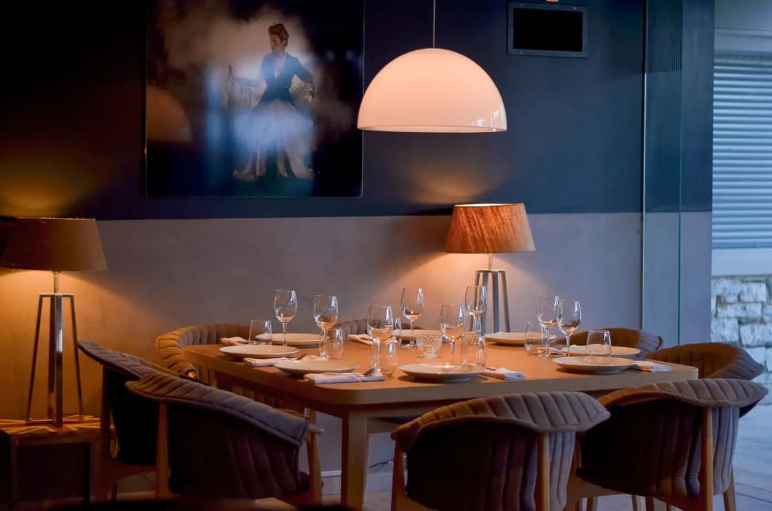 An elegantly set dining table with warm lighting, creating a cozy ambiance