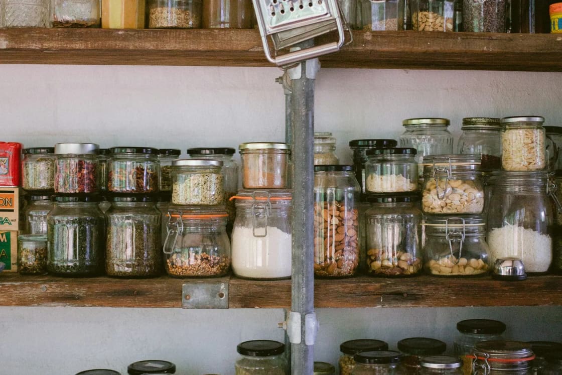 Wooden pantry shelves lined with glass jars of rice, beans, nuts and grains, the kind of home food storage many Utah families keep