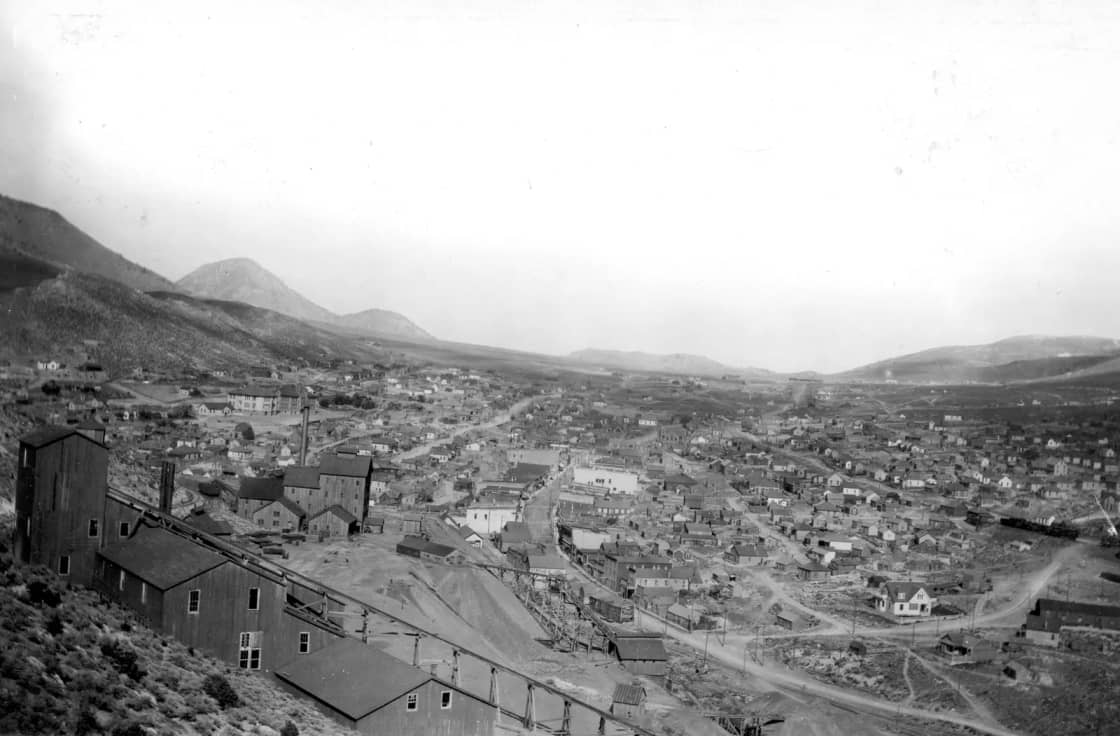 A 1911 panorama looking down over Eureka, Utah, with timber mine buildings in the foreground and houses filling the valley beyond