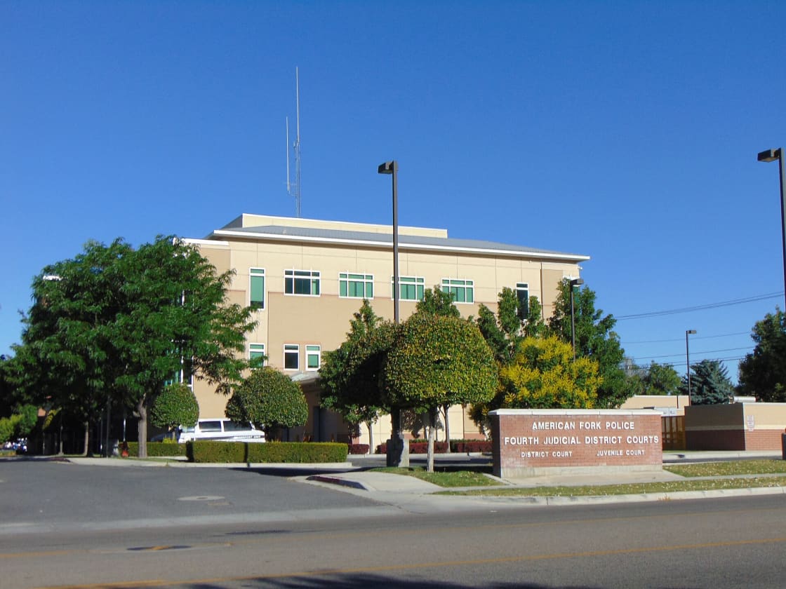 The low brick building housing the American Fork Police Department and the Fourth Judicial District Court, with its sign in the foreground