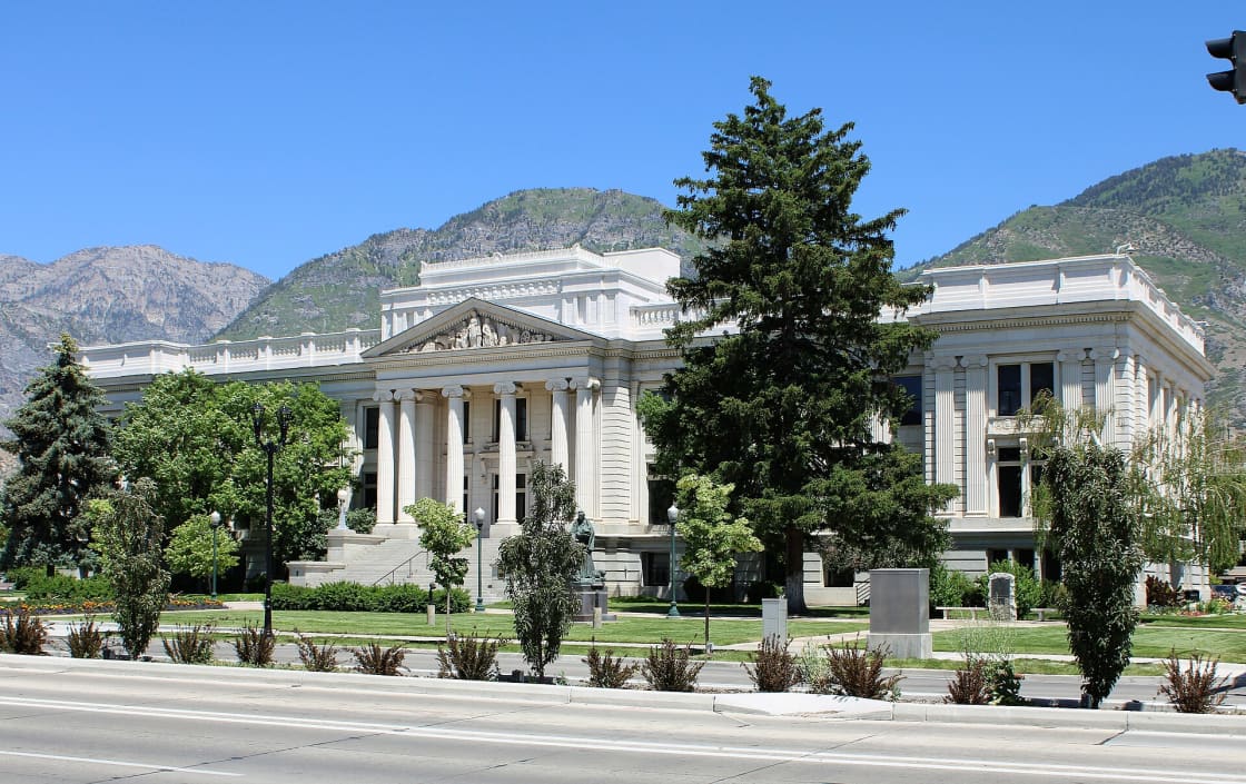 The neoclassical Utah County Historic Courthouse in downtown Provo, with the Wasatch mountains rising behind it