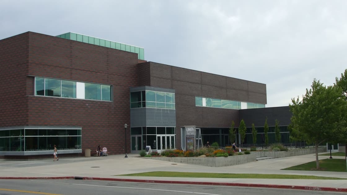 The Utah Museum of Fine Arts on the University of Utah campus, a long brick-and-glass building with a landscaped plaza in front