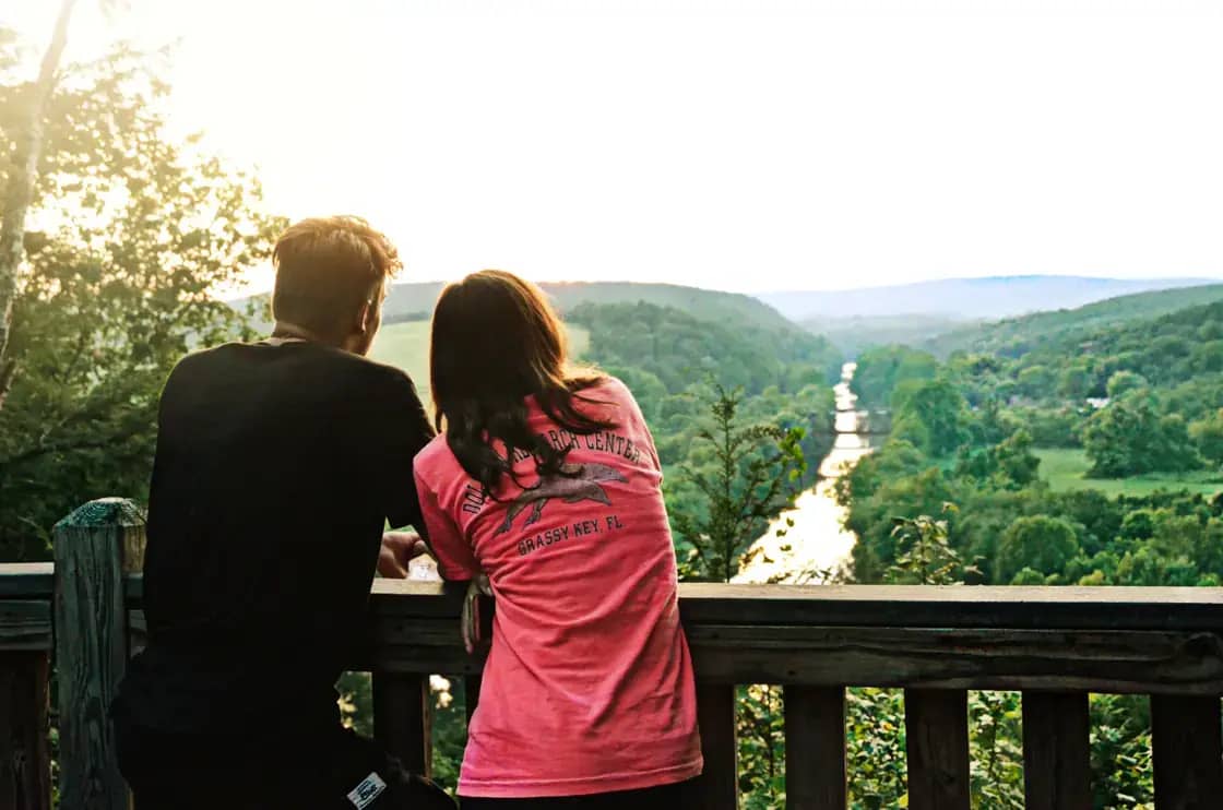 A couple watching the sunset together at a scenic overlook — honeymoon ideas for Utah Valley couples