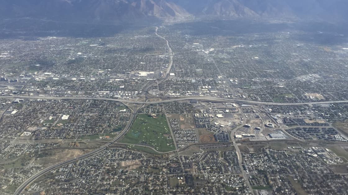 Seen from an airplane, the neighborhoods, freeways and interchanges of Midvale and its neighbors spread east across the southern Salt Lake Valley toward the Wasatch Mountains