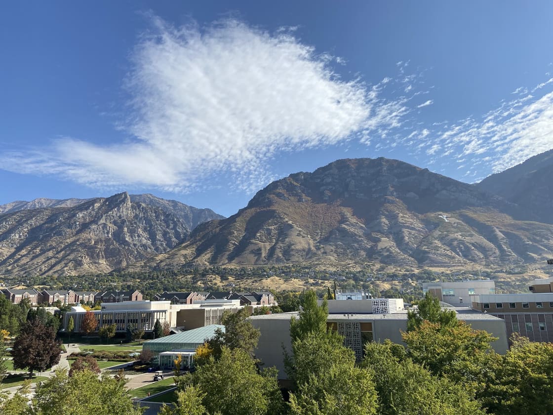 An elevated view across the BYU campus in Provo, Utah toward Y Mountain, with the white block Y visible on the hillside