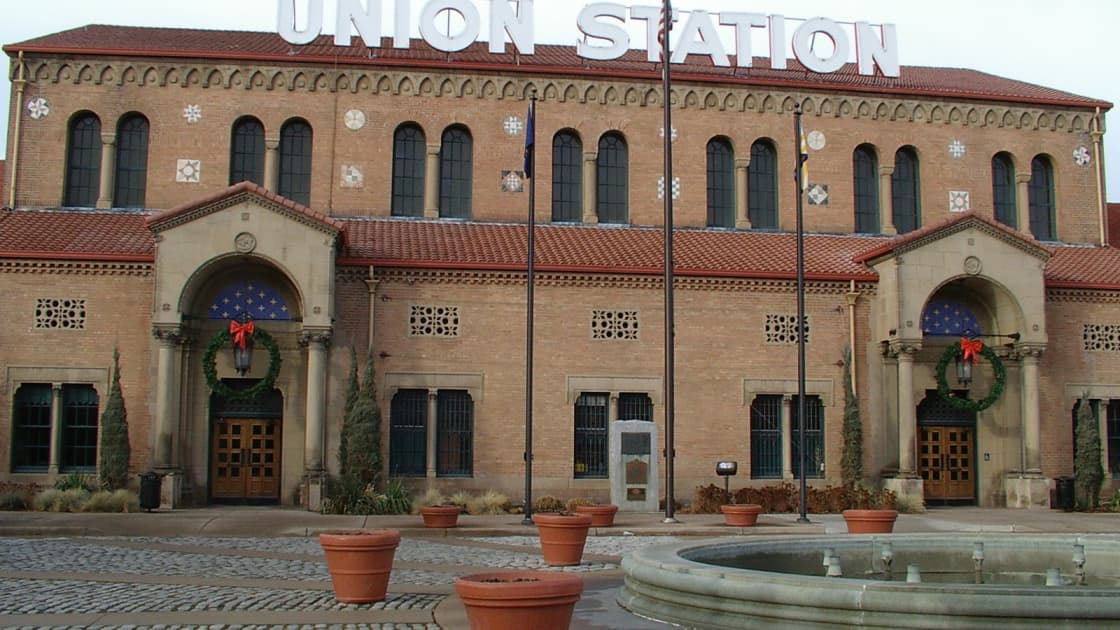 Ogden's Union Station in December, Christmas wreaths hung on its arched entrances beneath the big Union Station letters on the roof, with a fountain and planters in the plaza in front