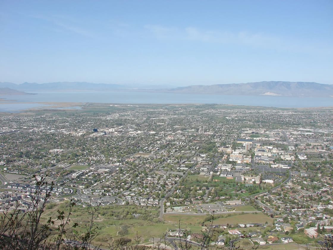 North Provo spread across the valley floor seen from high on Y Mountain, with Utah Lake and the mountains beyond its far shore