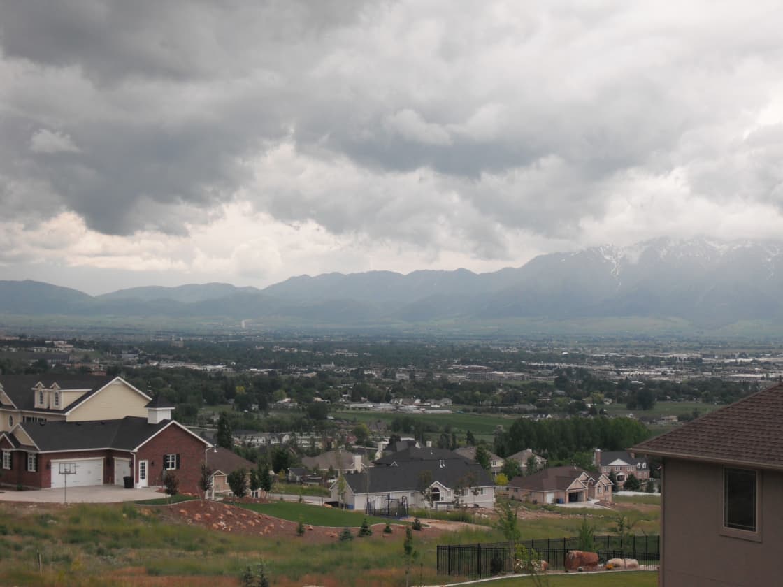 A view across Cache Valley, Utah toward the mountains, with houses on the bench in the foreground