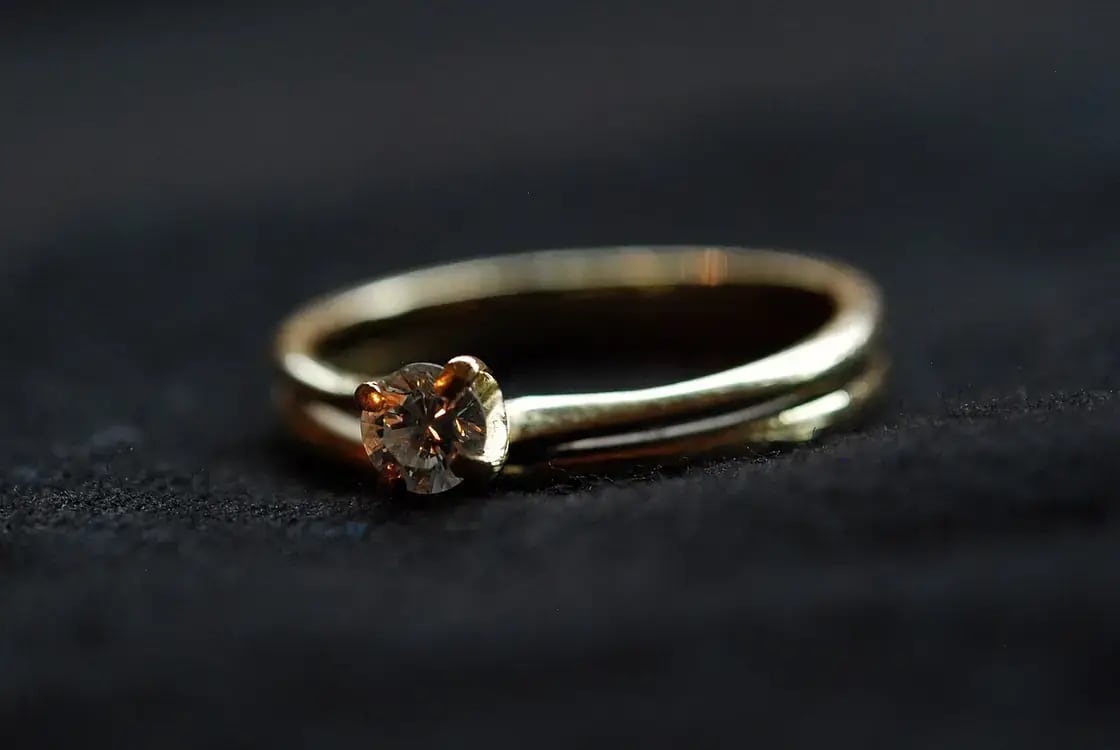 Engagement and wedding rings on a table — planning a Utah Valley wedding on a budget