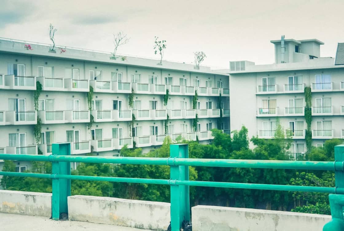 Contemporary apartment building surrounded by greenery, showcasing urban architecture