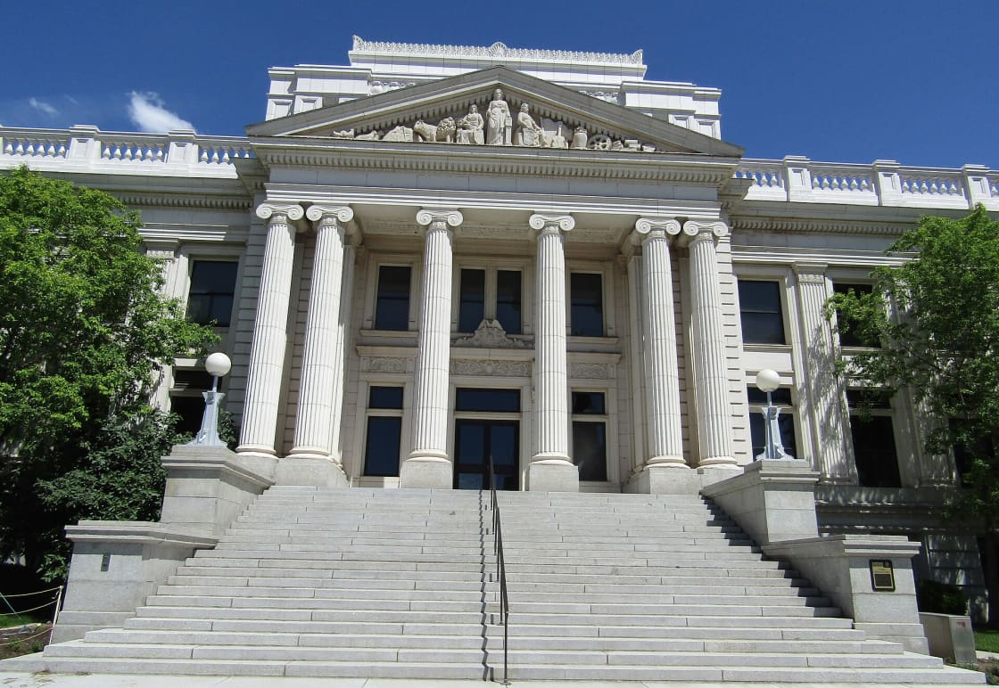 The columned stone facade and front steps of the Historic Utah County Courthouse in downtown Provo
