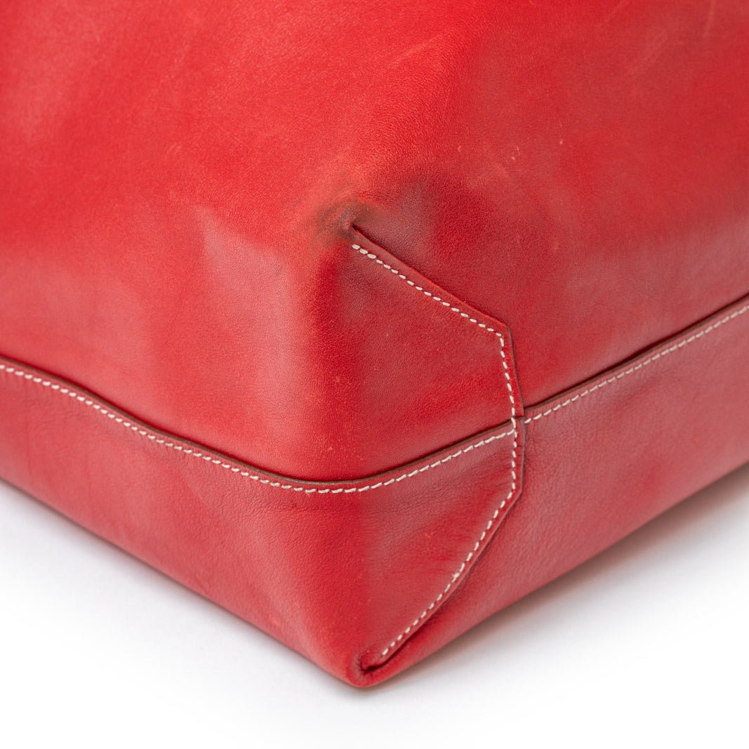 A true hand-saddle stitch sits at a subtle, elegant diagonal angle.