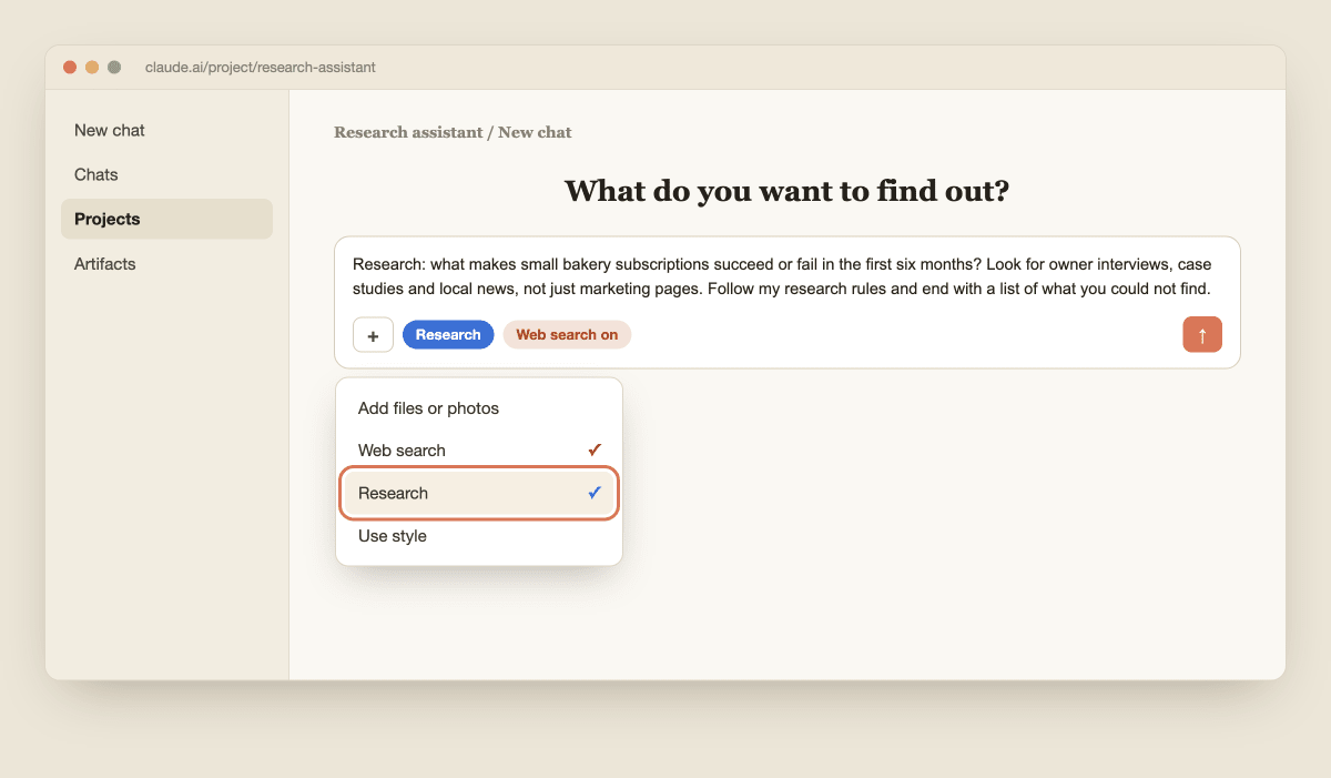 The plus menu in the Claude chat box with Research highlighted and a blue Research indicator under the message box