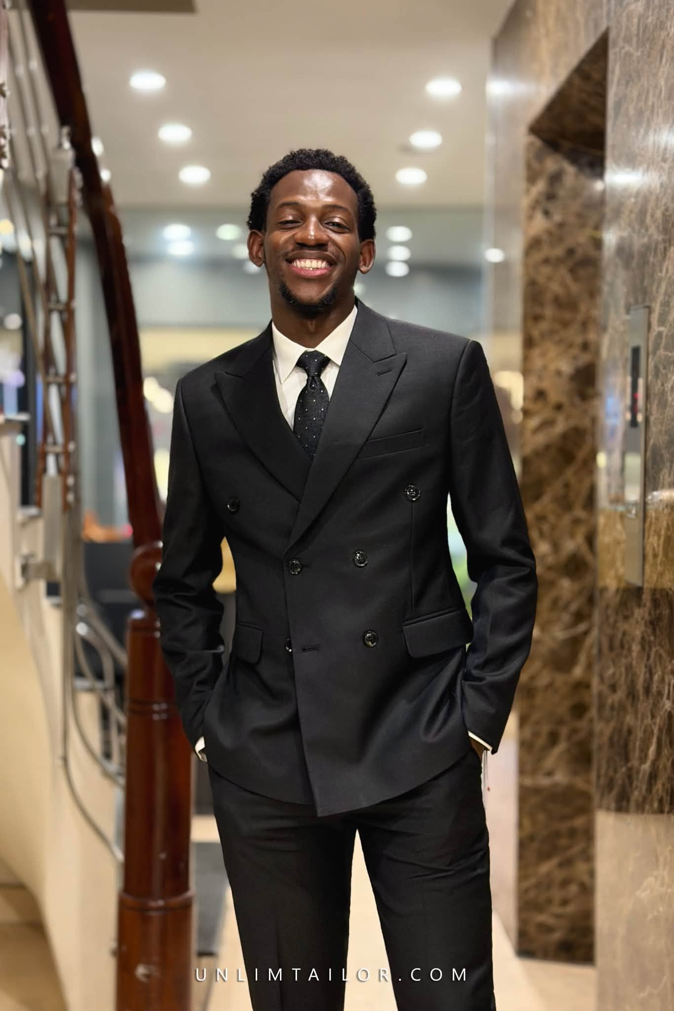 A mysterious black two-piece suit, double-breasted in style, tailored by Unlim Tailor in Hanoi.