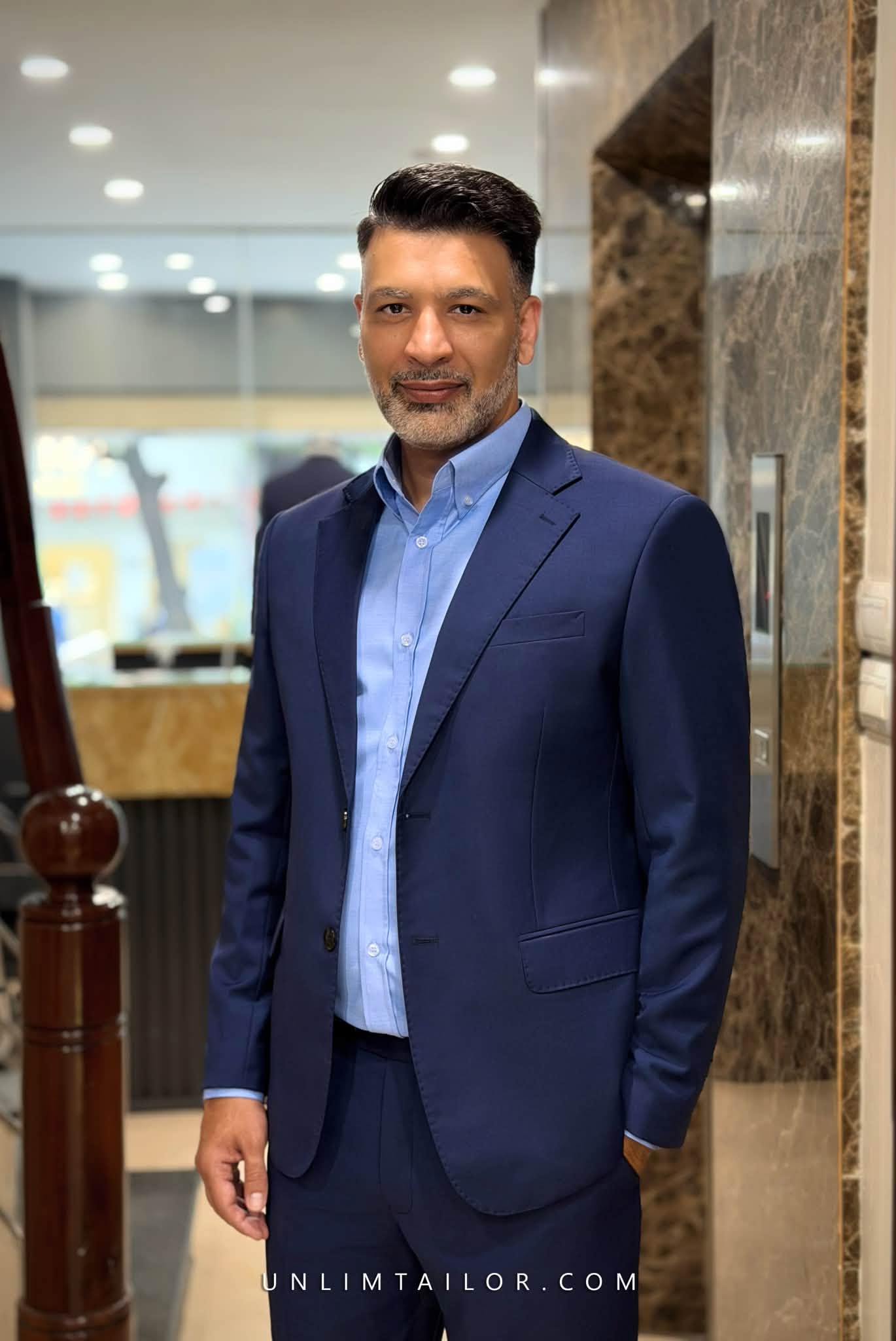 Unlim Tailor navy blue suit, featuring a two-button design and notch lapels.