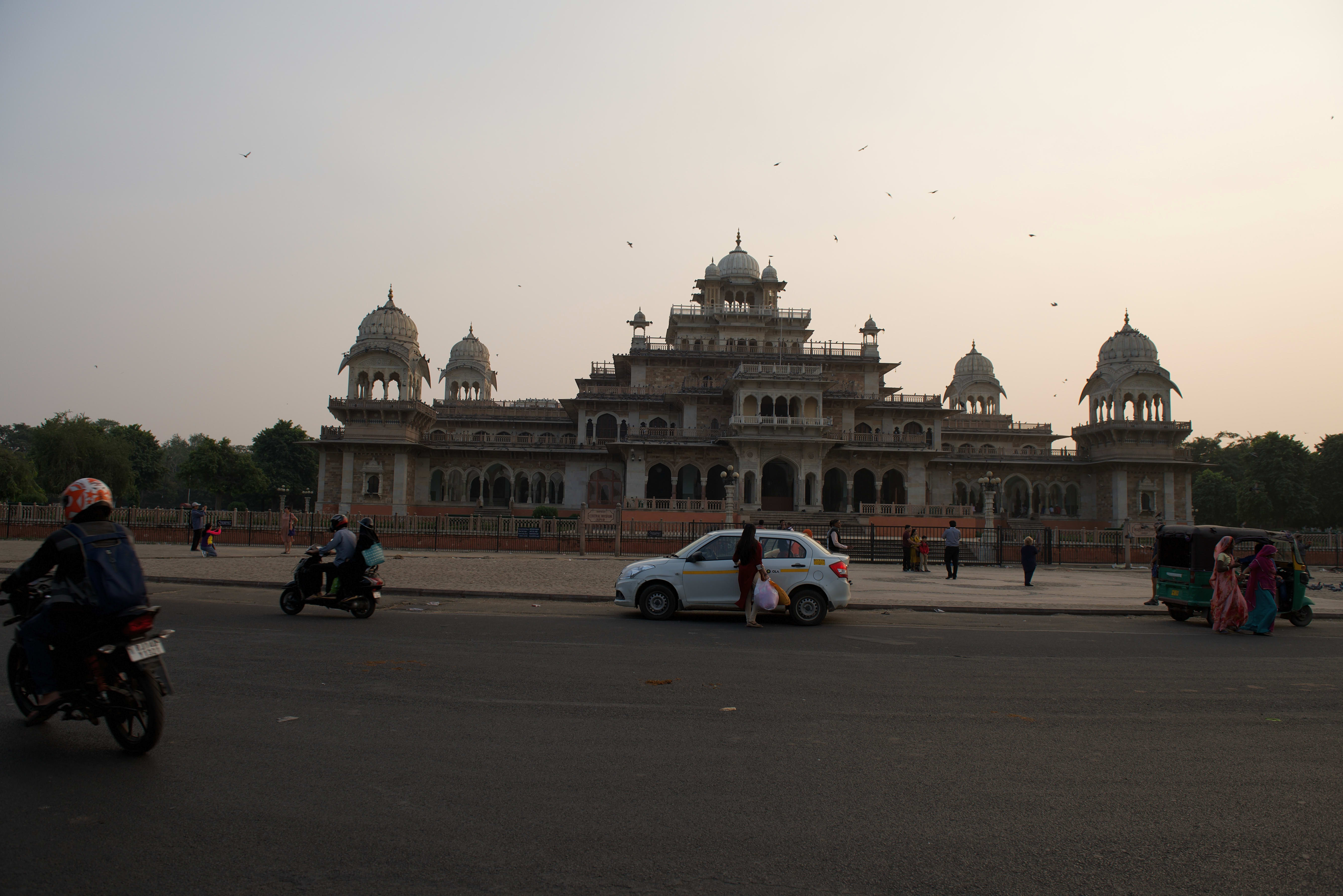 Albert Hall Museum in Jaipur, with birds in the air and traffic along its frontage.