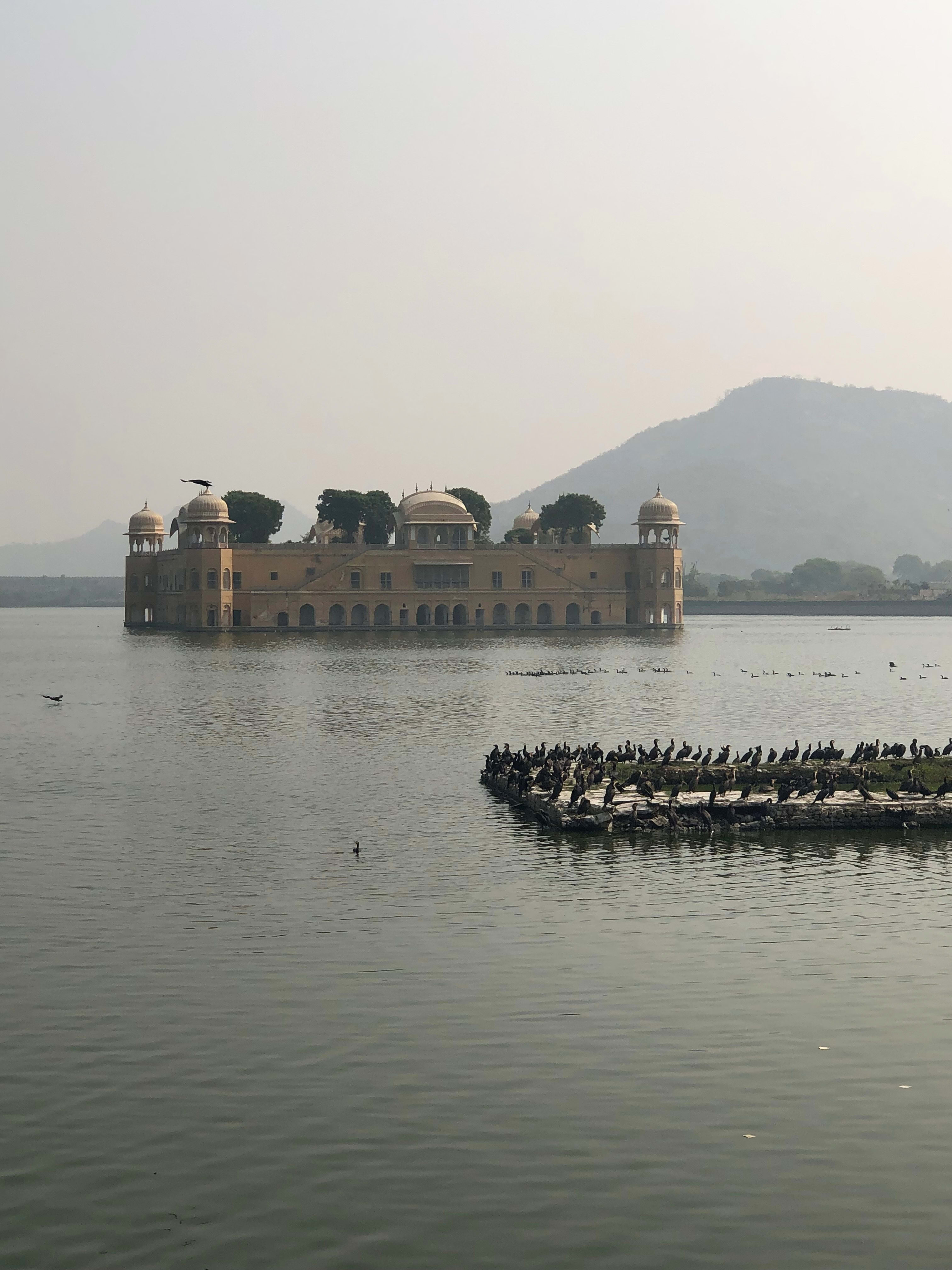 The Jal Mahal palace standing in Man Sagar Lake, Jaipur, seen through haze.