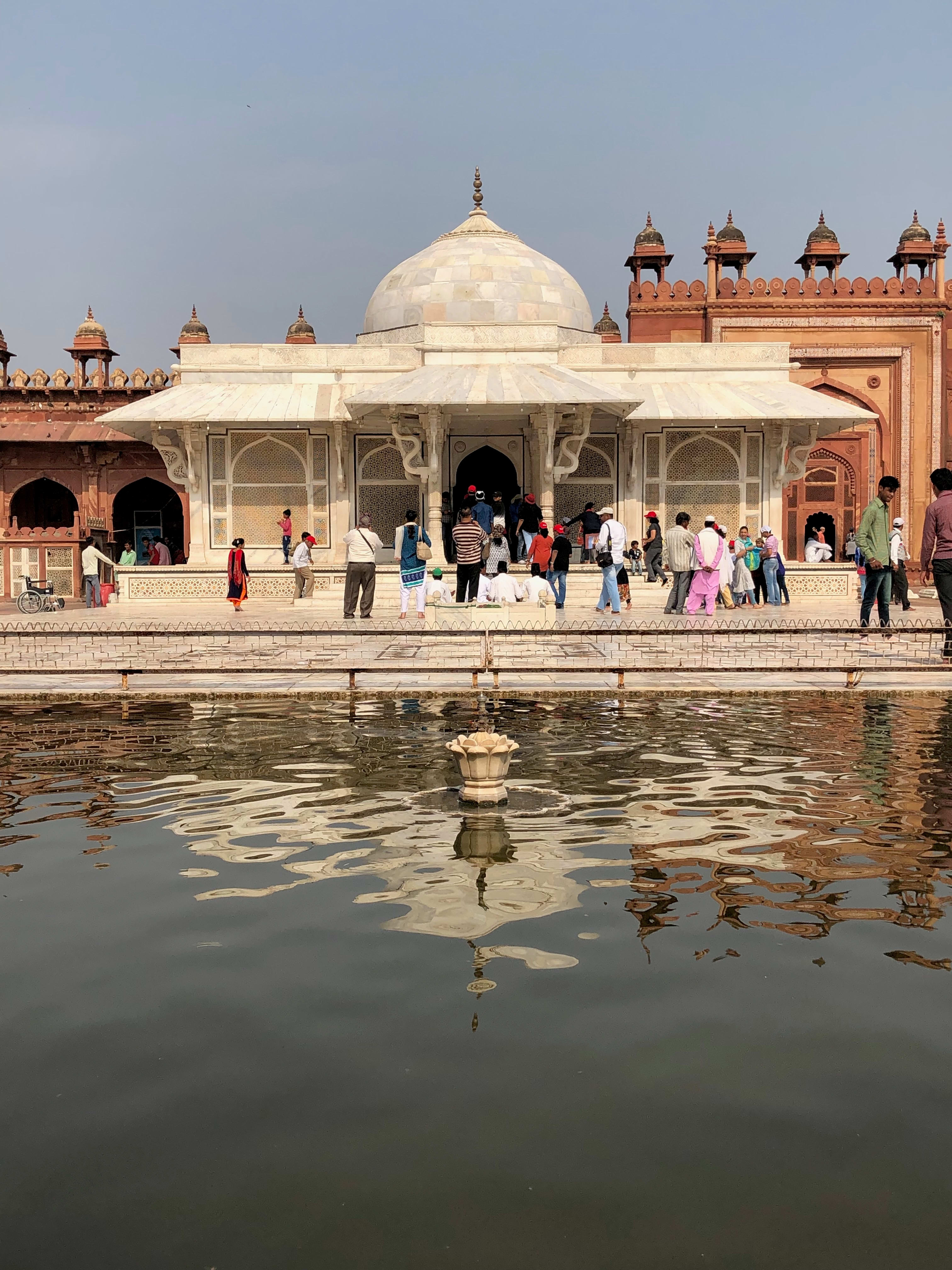 The white marble tomb of Salim Chishti and its reflection at Fatehpur Sikri.