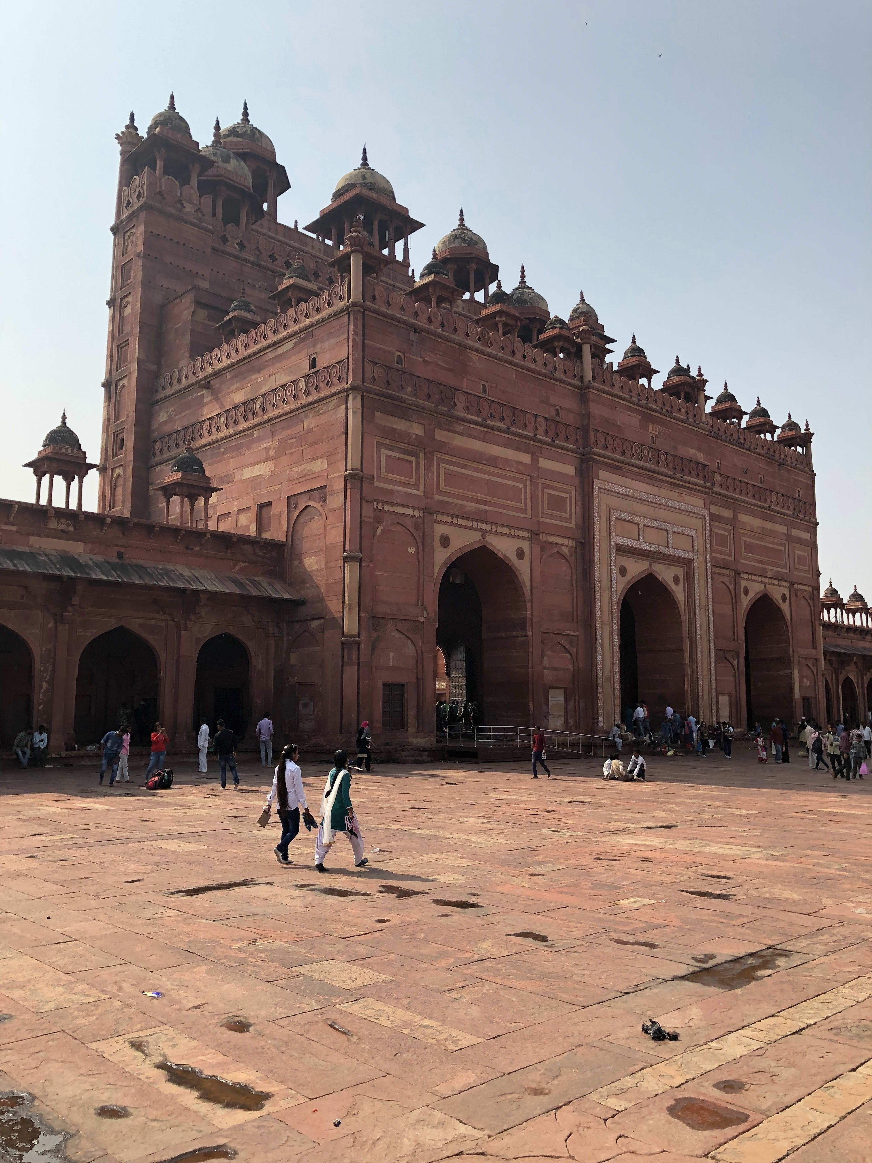 Red sandstone buildings surrounding the Jama Masjid courtyard at Fatehpur Sikri.