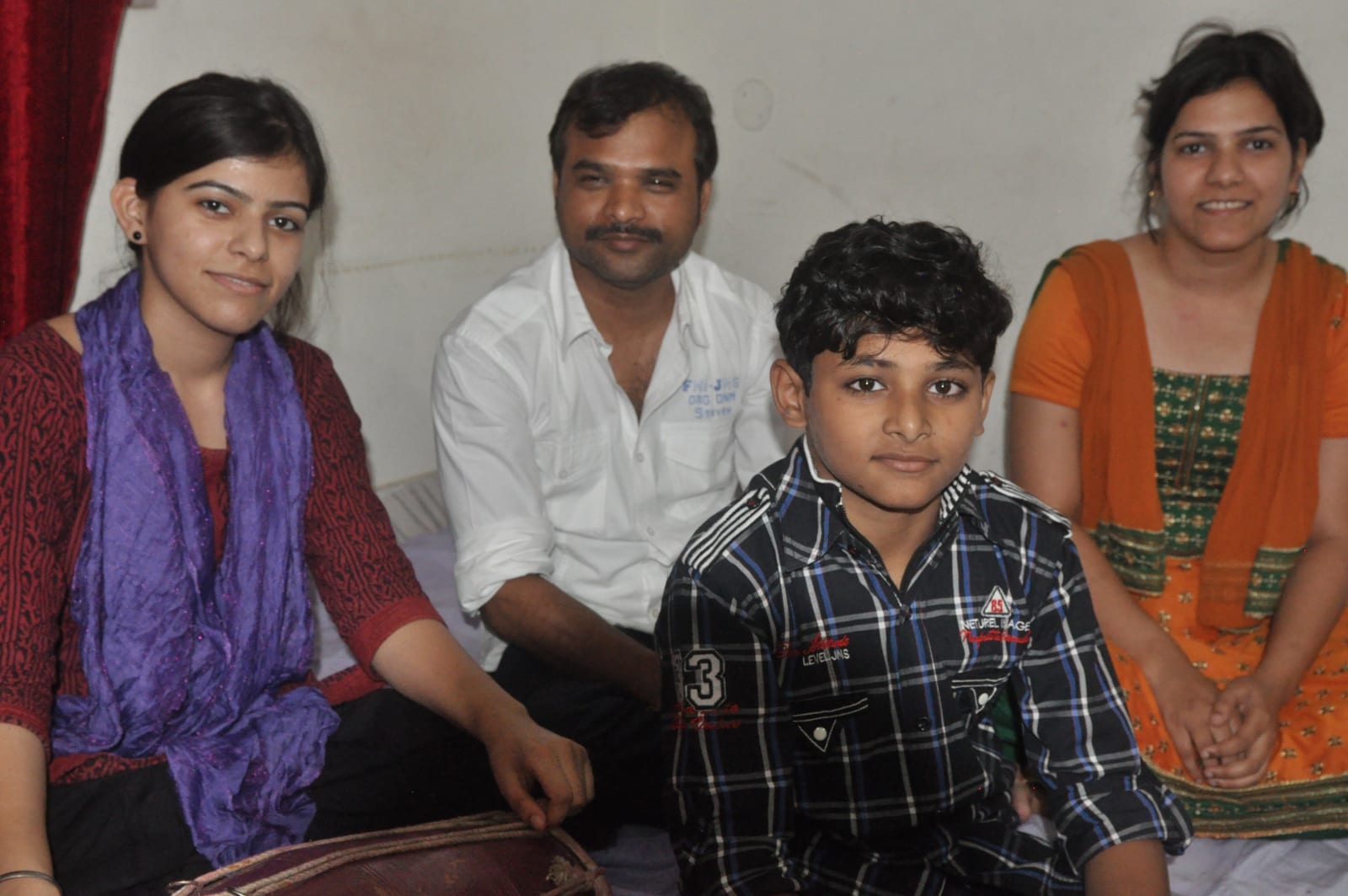 Two women, a man and a boy seated together, with the boy in front.