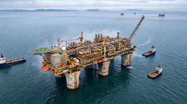 Concrete-legged offshore gas platform in the North Sea under pale morning light